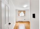 Spare room featuring hardwood / wood-style floors, ornamental molding, and a baseboard heating unit