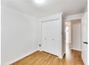 Unfurnished bedroom featuring light wood-style flooring, a closet, and ornamental molding