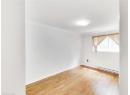 Spare room featuring a baseboard heating unit, light wood-style floors, and crown molding