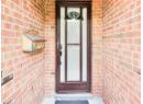 Property entrance with brick siding