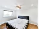 Bedroom featuring baseboard heating, dark wood-style floors, ceiling fan, crown molding, and recessed lighting