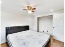 Bedroom with wood finished floors, recessed lighting, a closet, and a ceiling fan