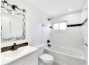 Bathroom featuring  shower combination and vanity