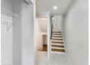 Stairway featuring baseboards and a baseboard heating unit