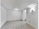 Finished below grade area featuring light wood-type flooring and stairway