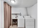 Laundry area featuring light wood finished floors and separate washer and dryer