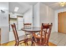 Dining space featuring light tile patterned floors and baseboards