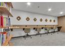 Carpeted home office with built in desk and recessed lighting