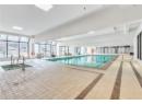 Indoor pool with a sink and a sunroom