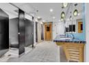 Full bathroom featuring double vanity, light tile patterned floors, and a closet
