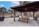 Surrounding community with a patio area and outdoor dining area