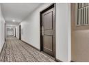 Corridor with carpet floors and recessed lighting