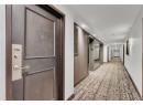 Hallway with recessed lighting and elevator