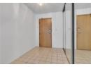 Entrance foyer with a textured ceiling and light tile patterned flooring