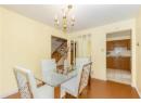 Dining room featuring light wood finished floors, a chandelier, and stairway