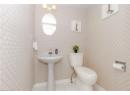 Bathroom with tile patterned floors and wallpapered walls