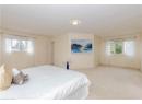 Bedroom with multiple windows and carpet floors