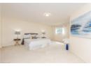 Carpeted bedroom with a textured ceiling and baseboards