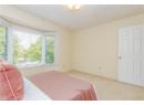 Carpeted bedroom featuring baseboards