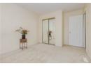 Unfurnished bedroom featuring light colored carpet and a closet