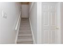 Staircase featuring baseboards and carpet flooring