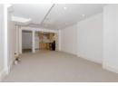 Unfurnished living room with light colored carpet and recessed lighting