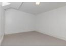 Carpeted spare room featuring baseboards