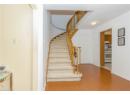 Stairway with wood finished floors and baseboards