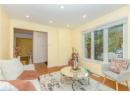 Living room with light wood-style floors and recessed lighting