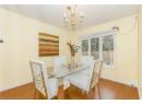 Dining space featuring wood finished floors and a chandelier