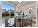 Dining space with arched walkways, a chandelier, recessed lighting, light tile patterned floors, and a tray ceiling