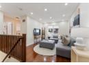 Living area featuring dark wood-style flooring and recessed lighting