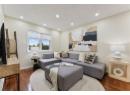 Living room with recessed lighting and dark wood-style flooring