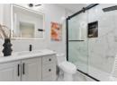 Full bathroom with vanity, a marble finish shower, and marble finish floors