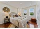Bedroom with dark wood finished floors and recessed lighting