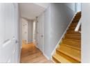 Staircase with wood finished floors and baseboards