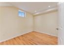 Basement with light wood-type flooring and recessed lighting
