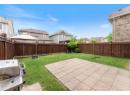 Fenced backyard featuring a residential view and a patio
