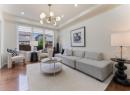 Living room with wood-type flooring, a chandelier, and recessed lighting