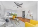 Living room featuring wood finished floors and a ceiling fan