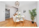 Dining space featuring light wood finished floors, a chandelier, and stairway