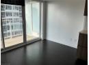 Unfurnished room with plenty of natural light and dark wood finished floors