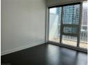 Spare room featuring healthy amount of natural light and dark wood finished floors