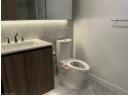 bathroom with vanity, light marble finish flooring, and tile walls