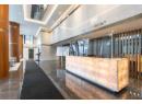 Reception with a towering ceiling and recessed lighting