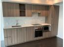 Kitchen with stainless steel appliances, tasteful backsplash, and modern cabinets