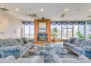 Living room featuring wood finished floors, recessed lighting, a high end fireplace, and a textured ceiling