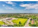 Aerial perspective of suburban area featuring a tree filled landscape